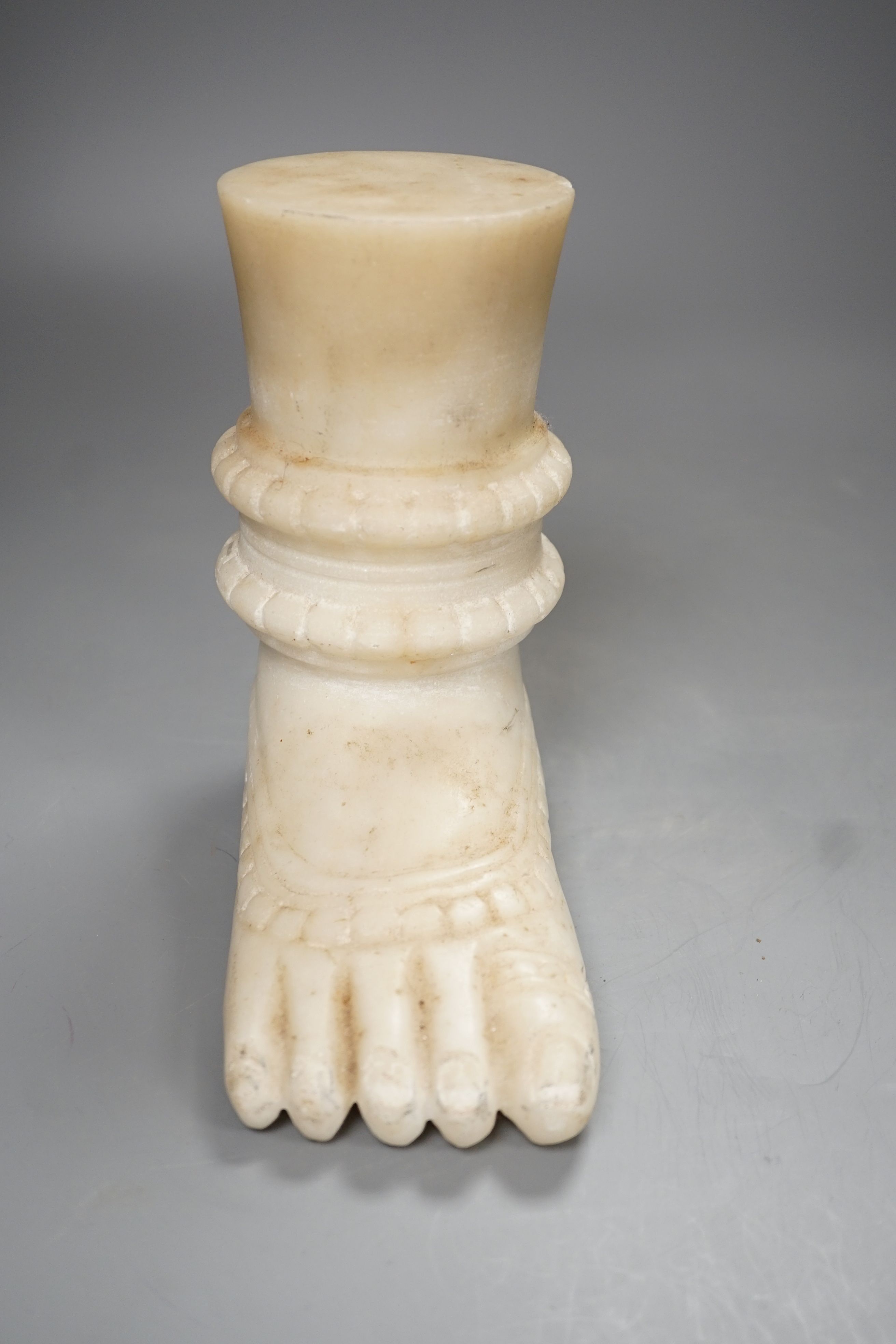 An Indian white marble foot of a deity - 18cm high